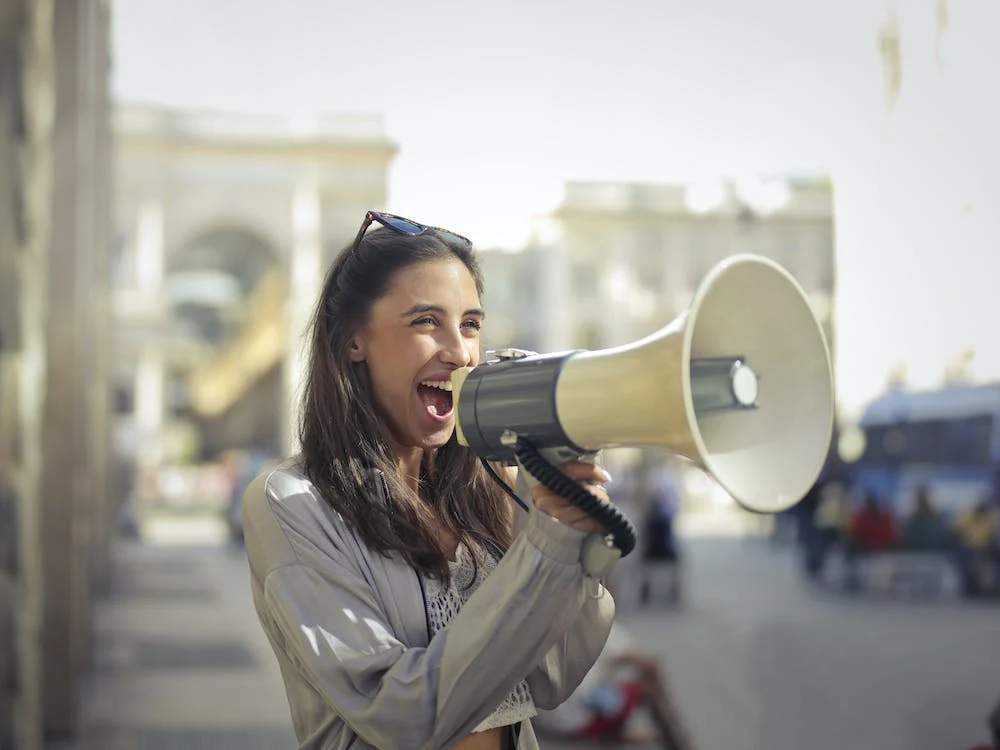 Woman on a megaphone as a metaphor for spreading the word about Maple.